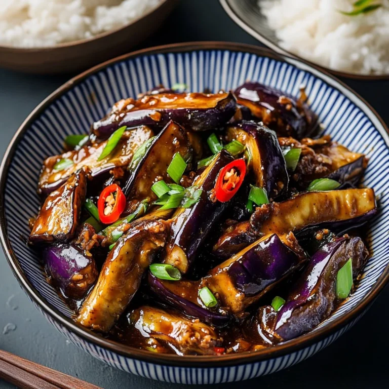 Stir-fried Chinese eggplant with garlic sauce in a serving dish.